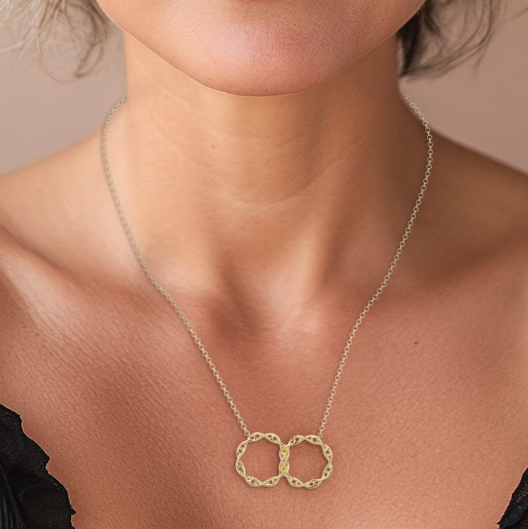 Close-up view of the gold vermeil interlocked DNA necklace, emphasizing the detailed craftsmanship of the intertwined DNA double helix structure.