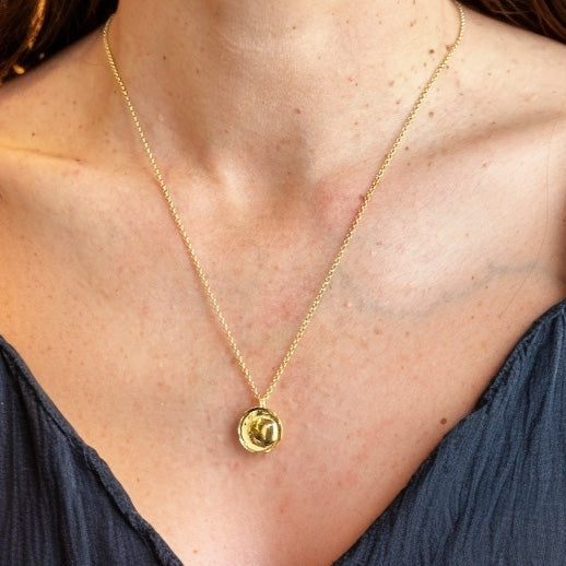 Immuno-chic lymphocyte necklace in gold vermeil on model, science-inspired jewelry celebrating immune system cells