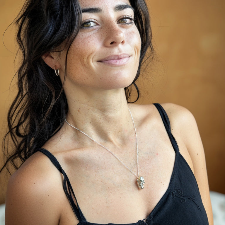 Model wearing the silver orangutan skull necklace, celebrating evolution and nature through elegant science jewelry by Science Jewelry 18:24.