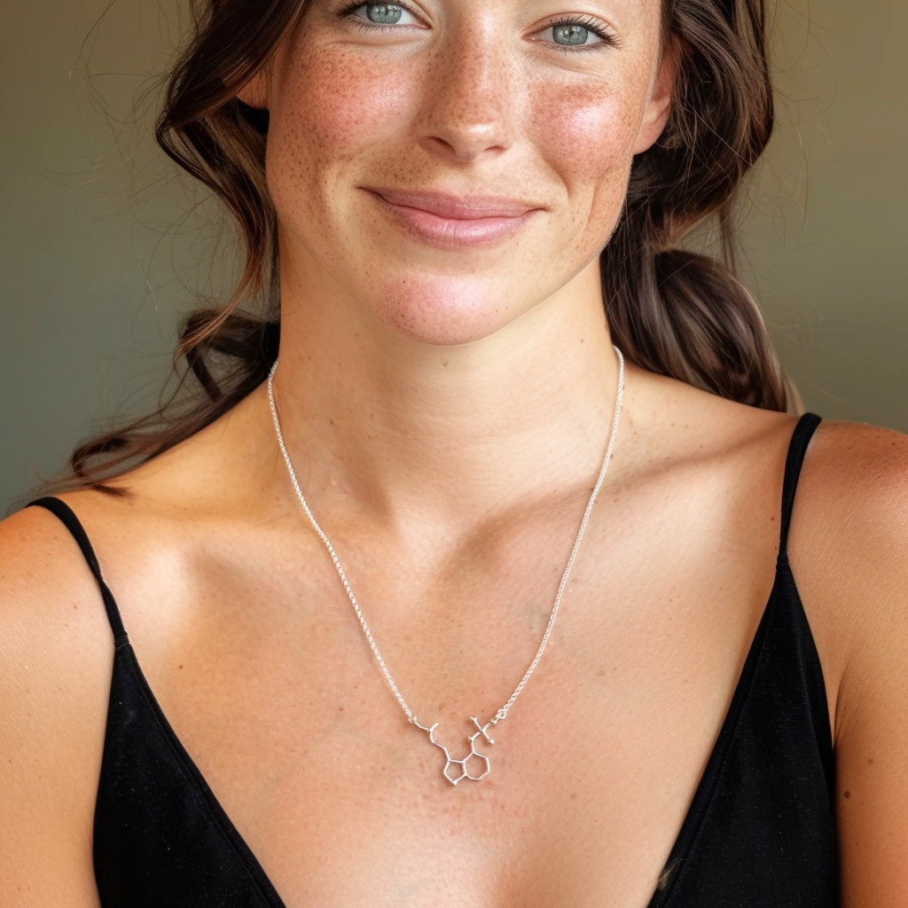 Woman wearing a psilocybin molecule necklace in sterling silver, elegant science-inspired jewelry designed for conversation starters and mindful living.