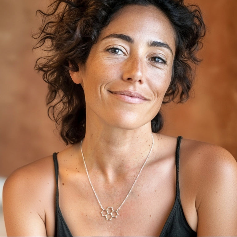Confident woman wearing the pyrene molecular necklace in sterling silver, styled casually — perfect jewelry for scientists, chemists, and curious minds who love modern science-inspired fashion.