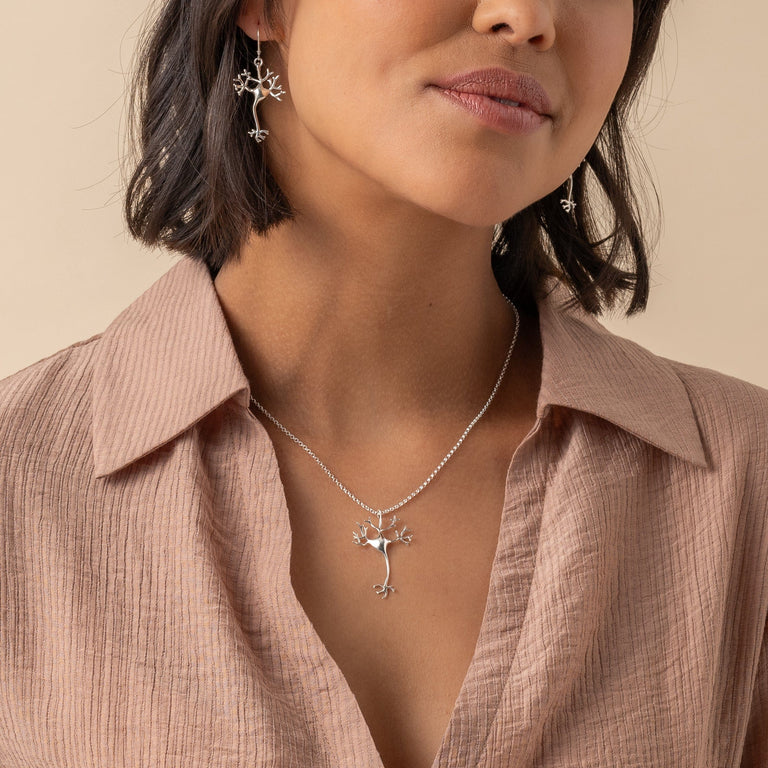 Silver Neuron Necklace on a model, illustrating its delicate design and science-inspired elegance.