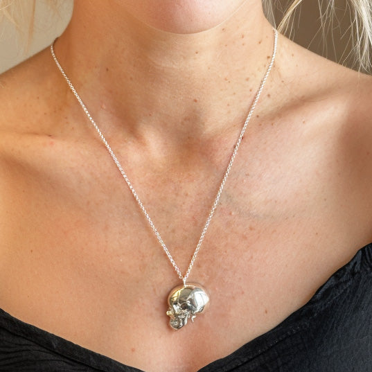 Close-up of sterling silver skull with vessels pendant – anatomical brain necklace for science lovers and medical professionals.
