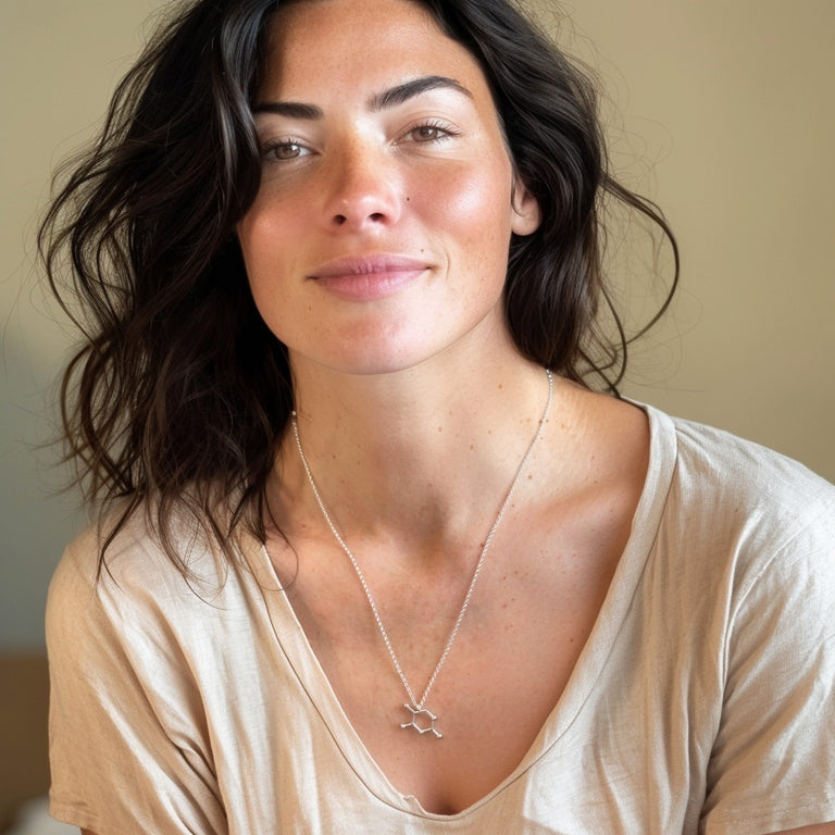 Smiling woman wearing the Thymine DNA necklace, styled casually to emphasize the blend of geeky charm and everyday elegance.