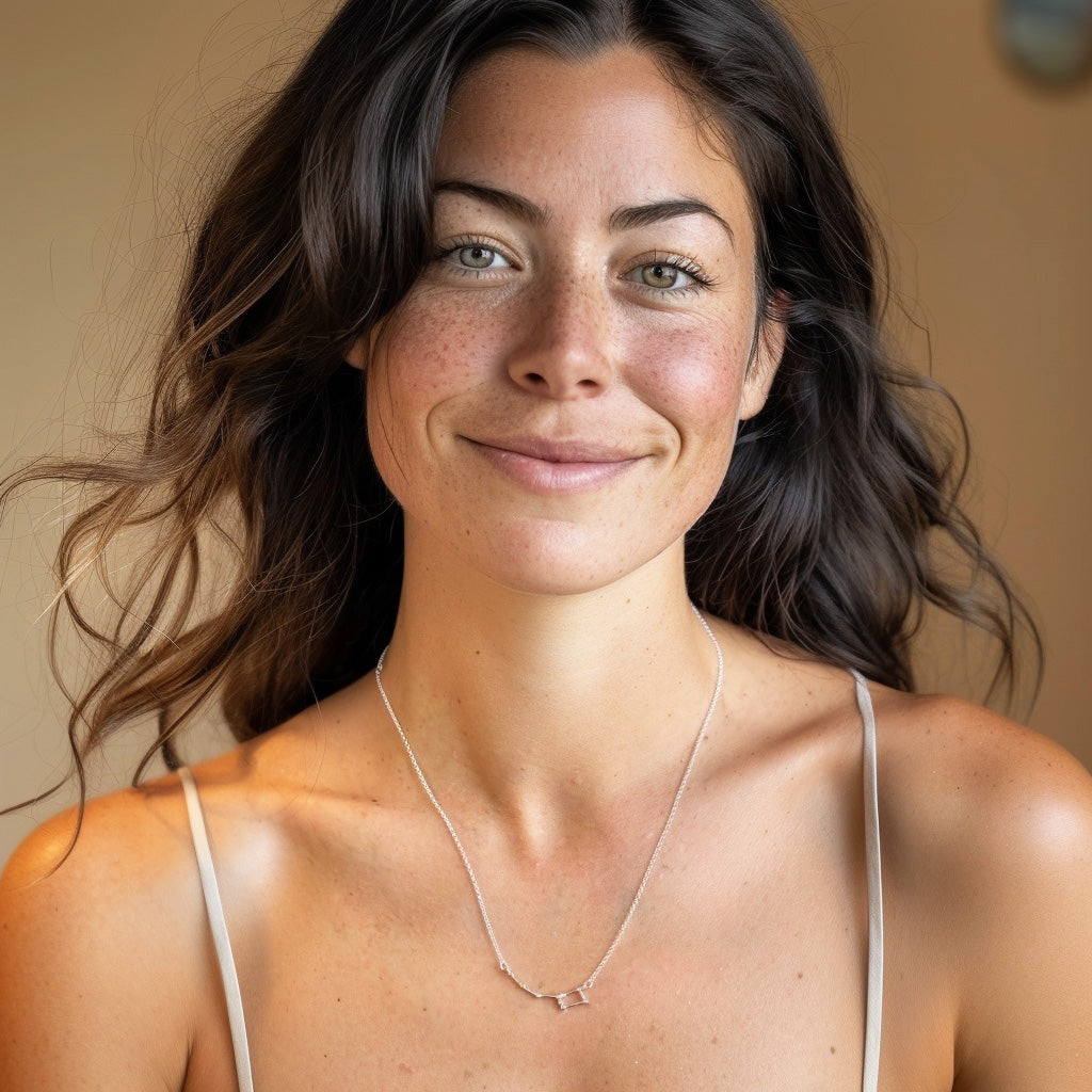 Smiling woman wearing the Ursa Minor constellation necklace in silver, featuring the Little Dipper design — elegant astronomy jewelry for scientists and celestial style enthusiasts.