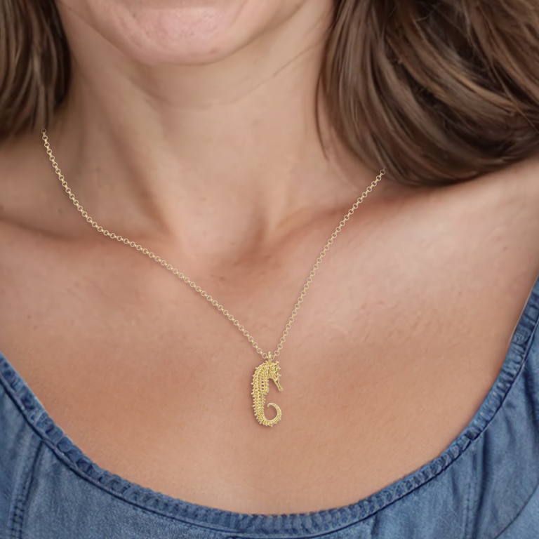 Close-up view of the gold vermeil seahorse skeleton necklace worn, highlighting its detailed craftsmanship.