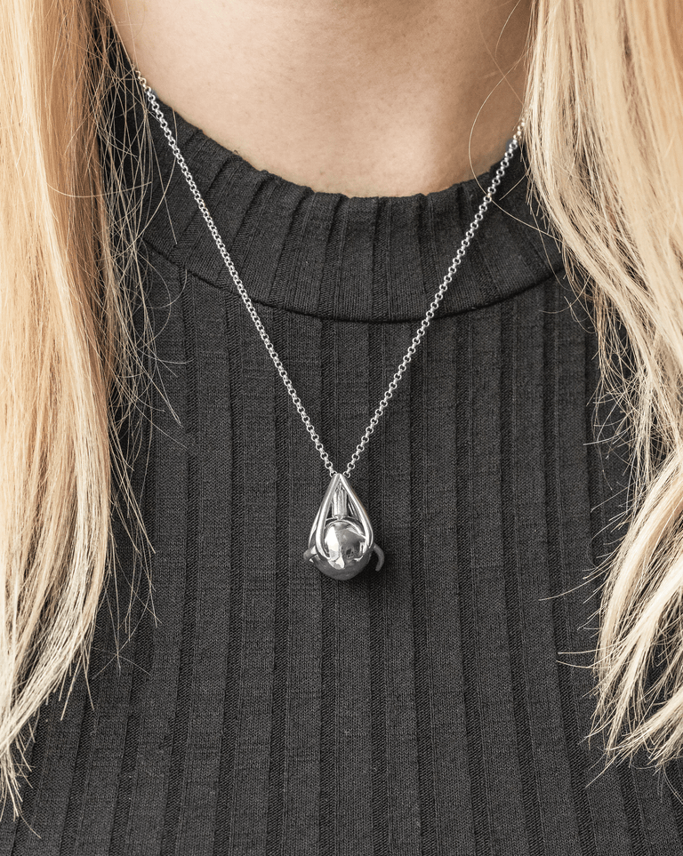 Model wearing the silver Eye Necklace, highlighting its delicate craftsmanship and scientific elegance.