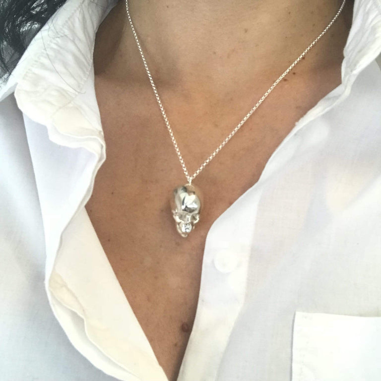 Close-up of silver skull necklace on model – detailed scientific skull design